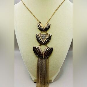3 stacked triangles with rhinestones and tassel pendant on a long chain. Glam